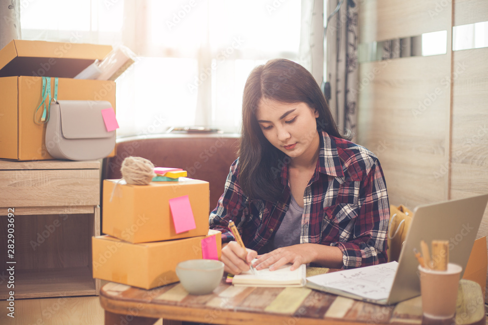 Small business online shopping, Social media marketing working at home, Asian woman working with computer laptop for shopping online. Small business online shopping, Social media marketing working at home, Asian woman working with computer laptop for shopping online.