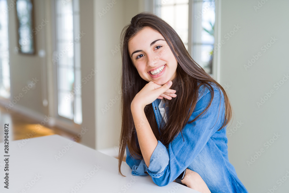 Beautiful young brunette woman smiling cheerful looking at the camera with a big smile on face showing teeth Beautiful young brunette woman smiling cheerful looking at the camera with a big smile on face showing teeth