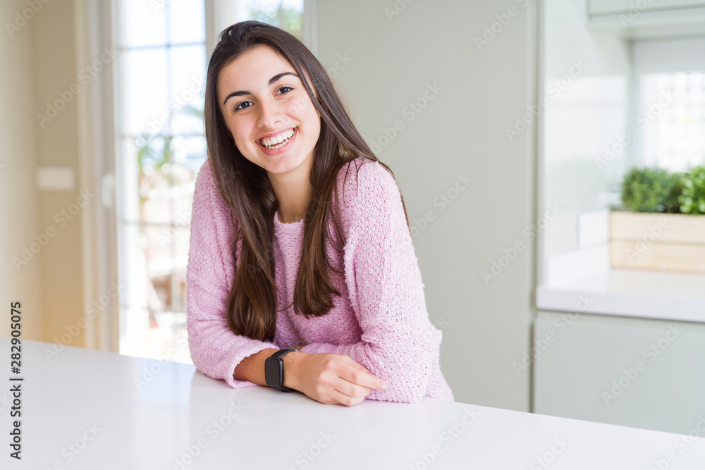 Beautiful young brunette woman smiling cheerful looking at the camera with a big smile on face showing teeth