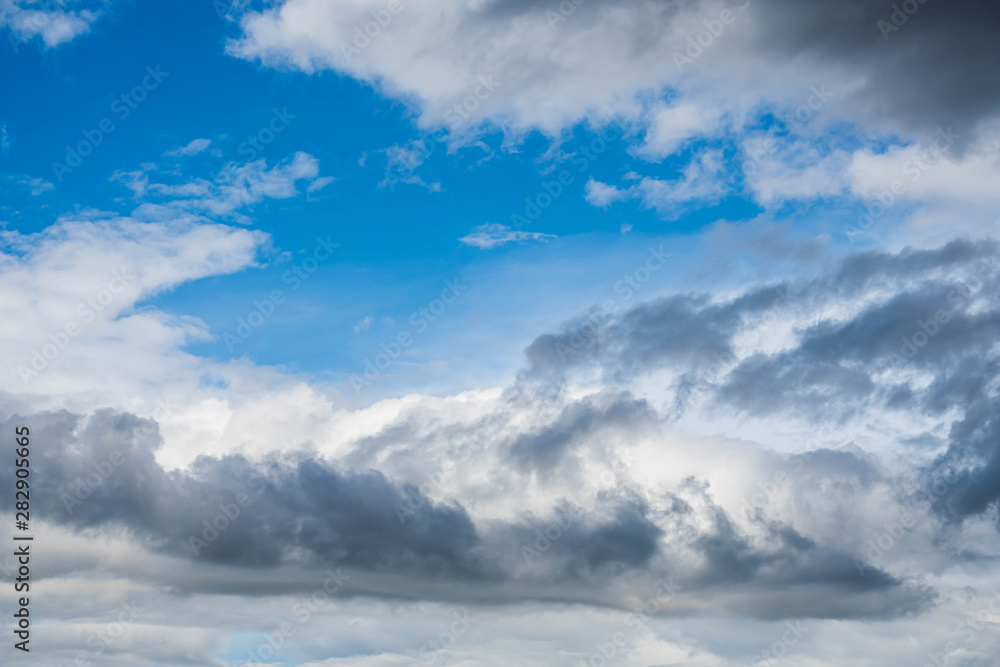Fototapeta premium Clouds near sunset before rain blue sky