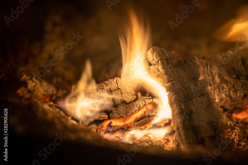 Wood burning at fireplace, captured as long exposure and close up shot for texture in woods.