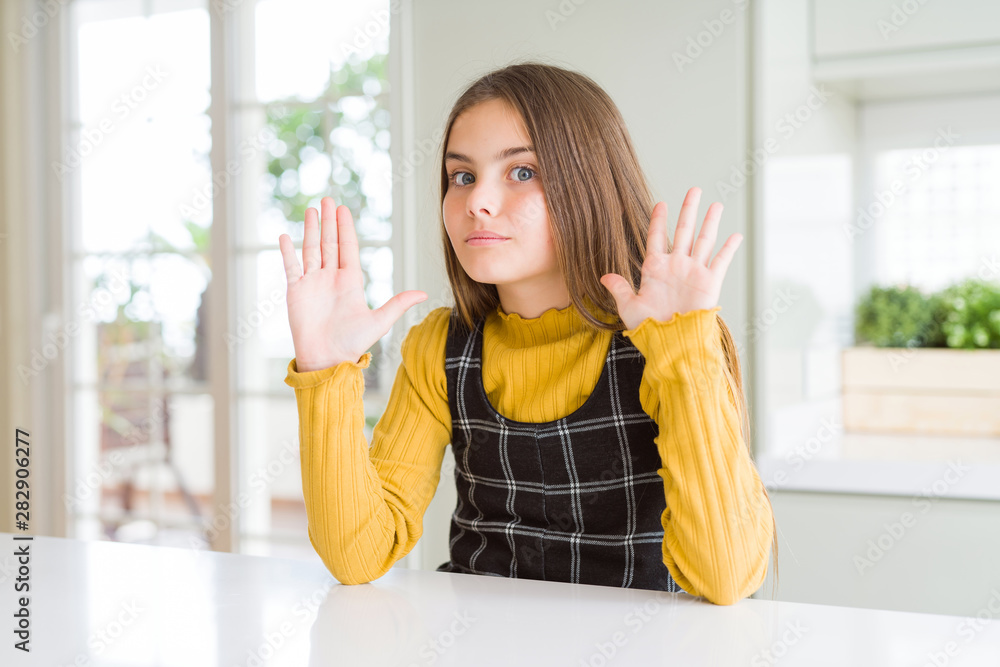 Young beautiful blonde kid girl wearing casual yellow sweater at home Moving away hands palms showing refusal and denial with afraid and disgusting expression. Stop and forbidden. Young beautiful blonde kid girl wearing casual yellow sweater at home Moving away hands palms showing refusal and denial with afraid and disgusting expression. Stop and forbidden.