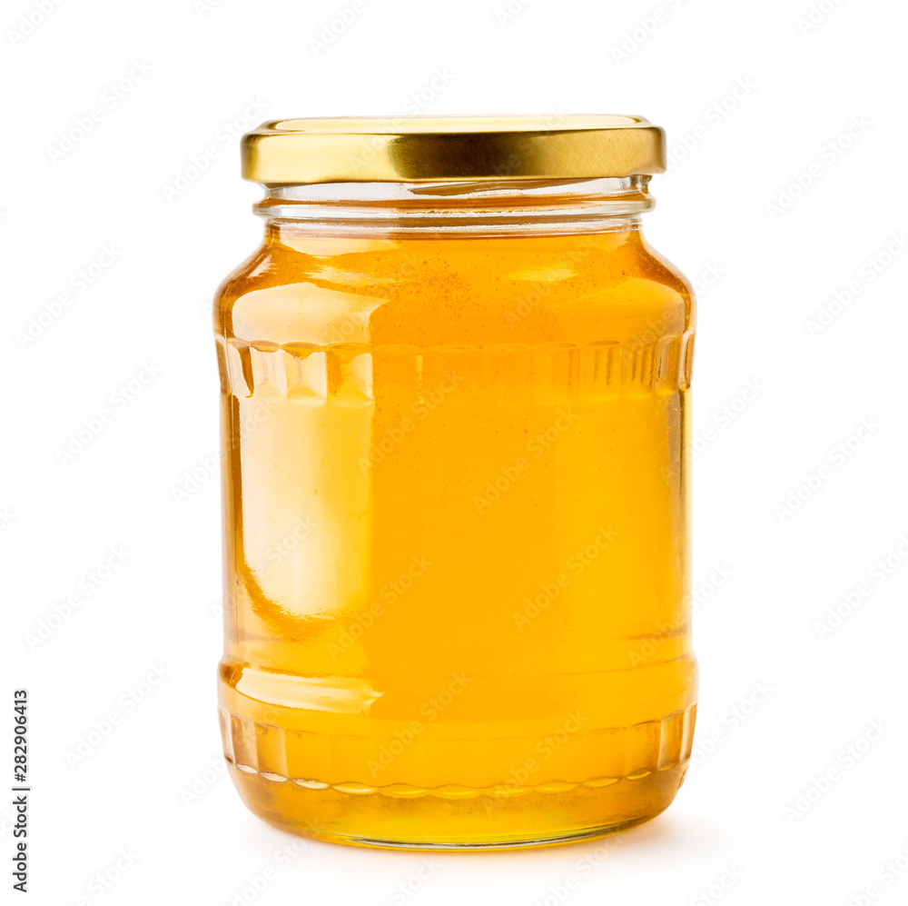 Honey in a glass jar close-up on a white. Isolated. Honey in a glass jar close-up on a white. Isolated.