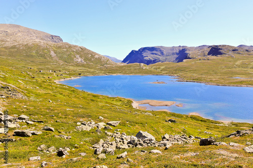 Beautiful Vavatn lake in the mountains. Summertime in Hemsedal, Buskerud, Norway. photo