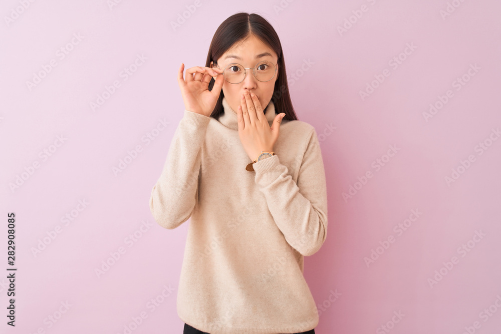 Young chinese woman wearing turtleneck sweater and glasses over isolated pink background cover mouth with hand shocked with shame for mistake, expression of fear, scared in silence, secret concept Young chinese woman wearing turtleneck sweater and glasses over isolated pink background cover mouth with hand shocked with shame for mistake, expression of fear, scared in silence, secret concept