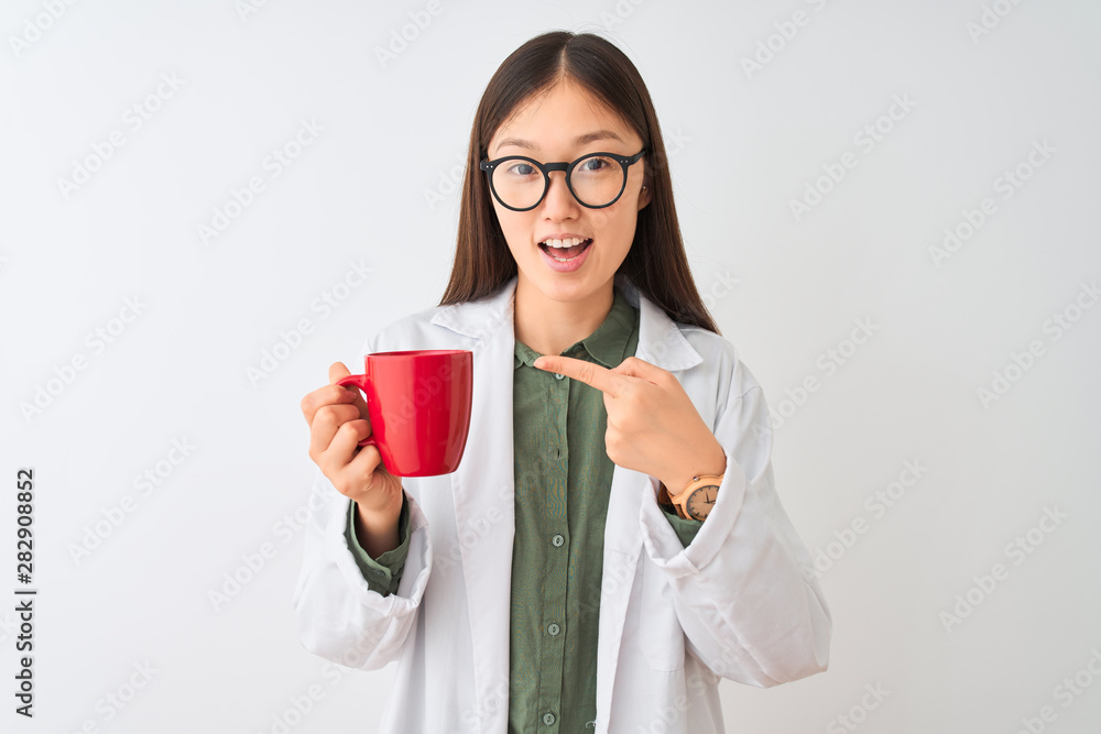 Young chinese dooctor woman wearing glasses drinking coffee over isolated white background very happy pointing with hand and finger Young chinese dooctor woman wearing glasses drinking coffee over isolated white background very happy pointing with hand and finger