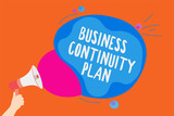 Writing note showing Business Continuity Plan. Business photo showcasing creating systems prevention deal potential threats Man holding Megaphone loudspeaker screaming colorful speech bubble