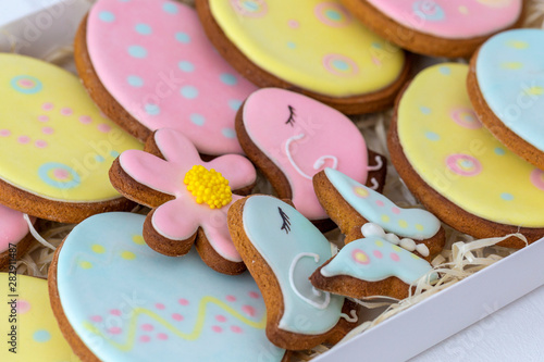 Closeup top view of colorful cookies for Easter holiday celebration in paper box. Horizontal color photography.