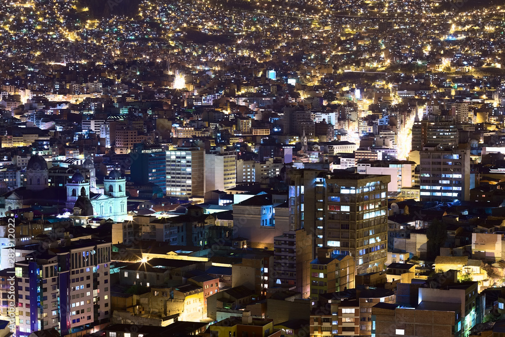 View over the city center of La Paz, Bolivia at night. On the left side the Metropolitan Cathedral on Murillo Square can be seen.