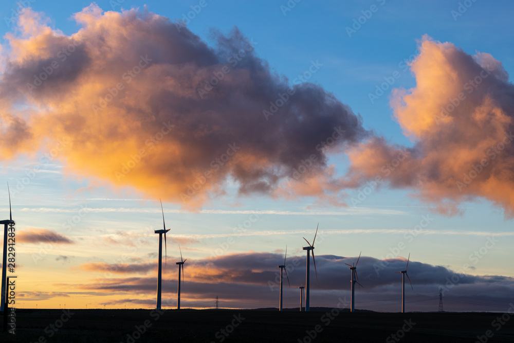 Windmills porwer plant at sunset