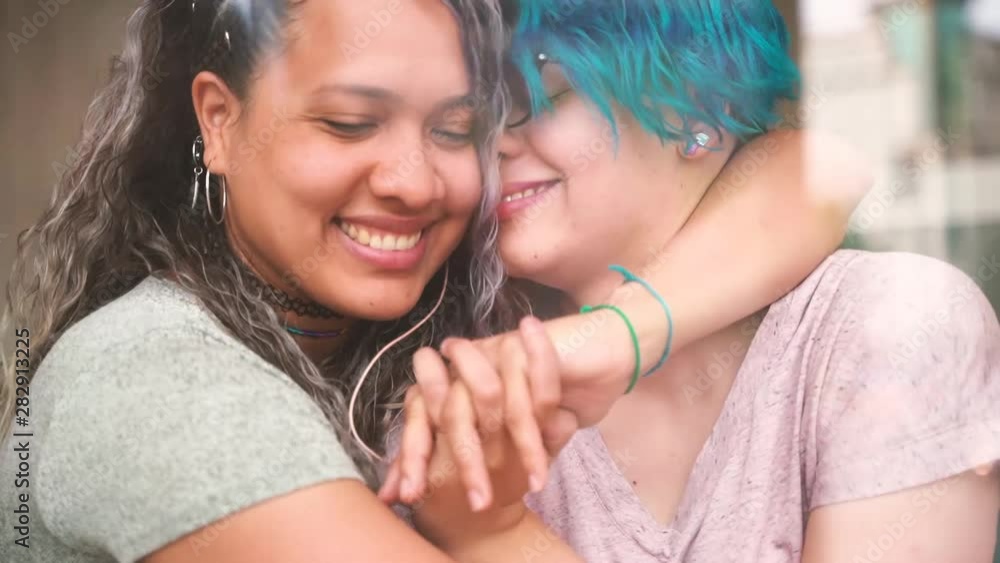 Lesbian teen couple kissing in a public place. Not embarrassed of their sexuality. Proud to be gay. Tender gay couple showing affection and love. Right to be free and happy. vídeo de Stock | Adobe Stock