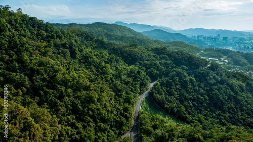 Mountain road through forest in Taiwan. Beautiful elevated view of an empty way.