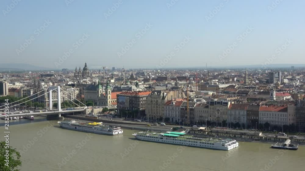 Hungary, Budapest, June 12, 2019. View of embankment of city Budapest and pier with cruise boats on Dubabe river. Hungary, Budapest, June 12, 2019. View of embankment of city Budapest and pier with cruise boats on Dubabe river.