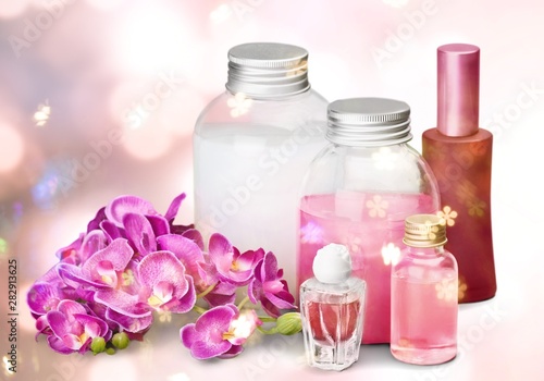 Bottles with organic essential aroma oils on background