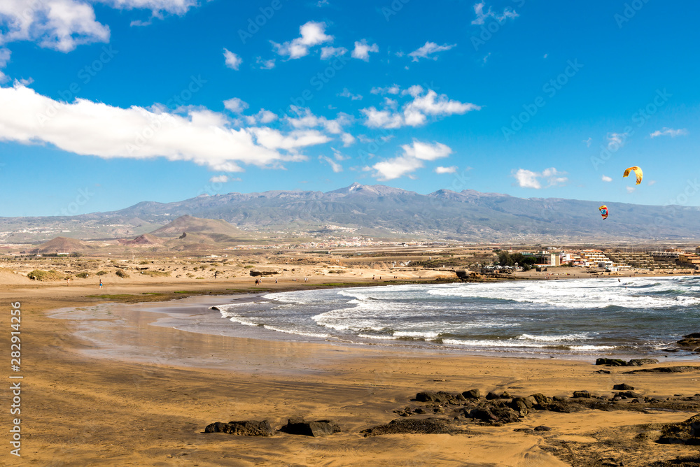 A view of Playa Leocadio Machado beach and mountain range in background. El Medano, Tenerife, Spain