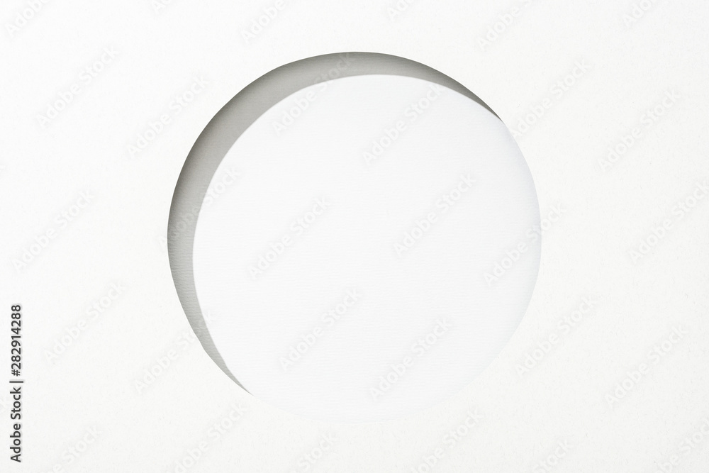 cut out round hole in white paper on white simple background cut out round hole in white paper on white simple background