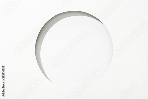 cut out round hole in white paper on white simple background