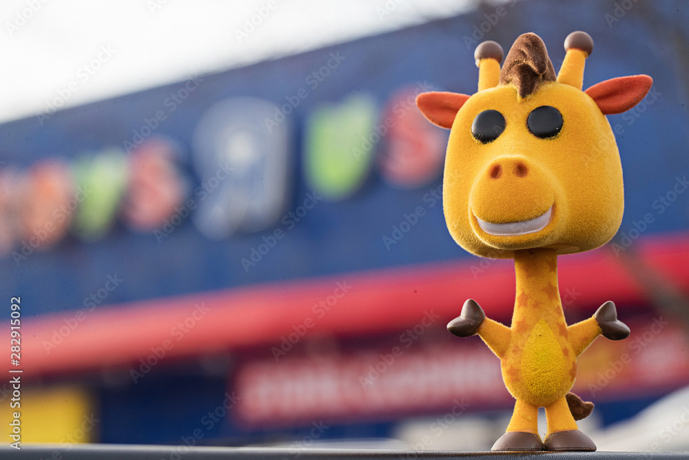 General view of Geoffrey the Giraffe flocked Funko Pop in front of Toys R Us  sign in Everett, Washington on March 23, 2019 Stock Photo | Adobe Stock