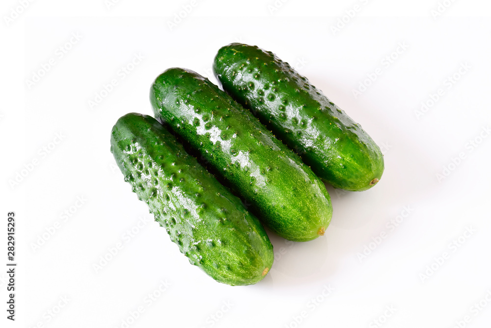 Set of wet fresh green cucumbers on a white isolated background. Set of wet fresh green cucumbers on a white isolated background.