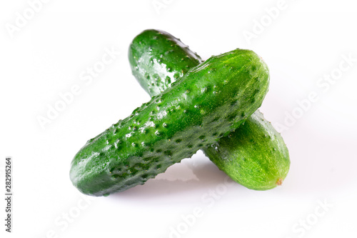 Set of wet fresh green cucumbers on a white isolated background.