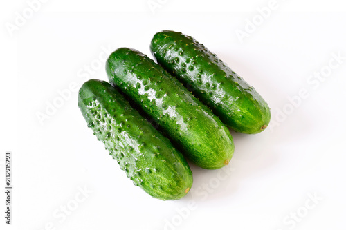 Set of wet fresh green cucumbers on a white isolated background.