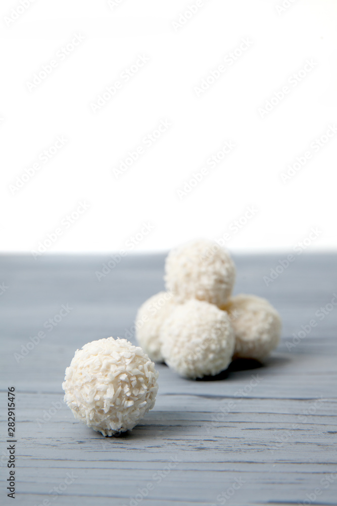 sweets with coconut and almonds on wooden table sweets with coconut and almonds on wooden table
