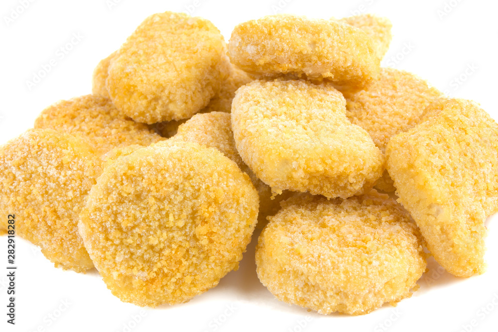 Frozen nuggets on a white background. Several chicken nuggets in breading close-up on a white background. Frozen nuggets on a white background. Several chicken nuggets in breading close-up on a white background.