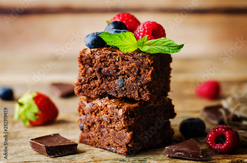 Chocolate brownie with berries and mint leaves