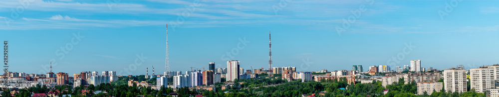 Before us is a panorama of the city Hills district of Perm. Trees, high-rise buildings, television towers are illuminated by the rays of the rising dim June sun.
