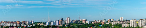 Before us is a panorama of the city Hills district of Perm. Trees, high-rise buildings, television towers are illuminated by the rays of the rising dim June sun. © Alexander