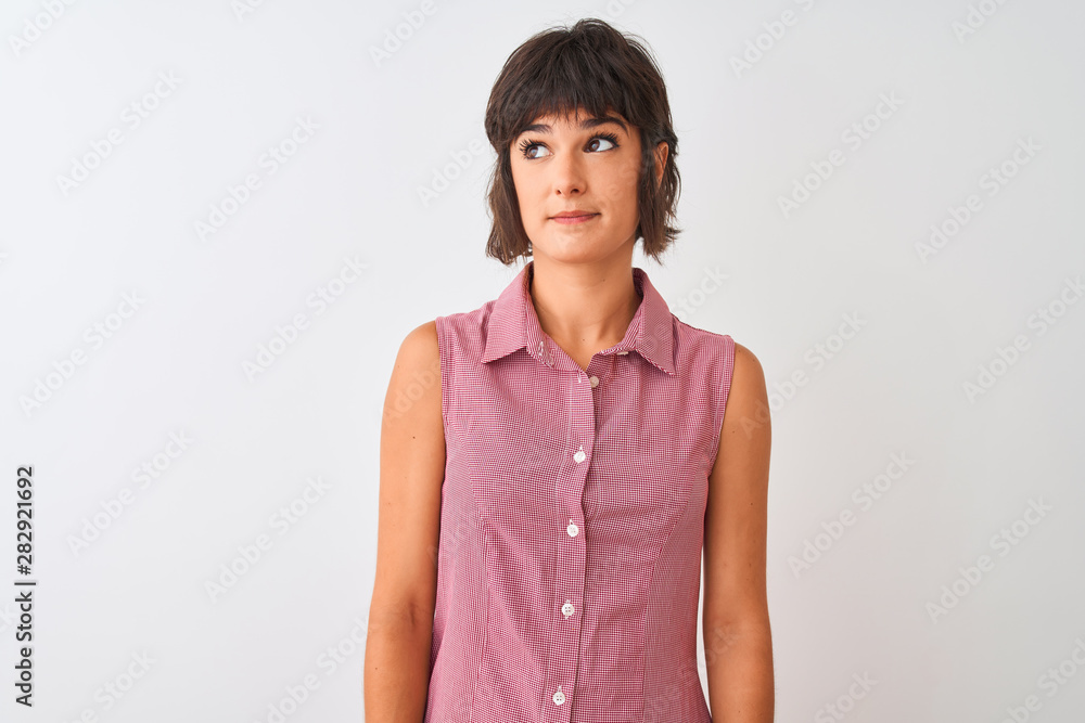Young beautiful woman wearing red summer shirt standing over isolated white background smiling looking to the side and staring away thinking. Young beautiful woman wearing red summer shirt standing over isolated white background smiling looking to the side and staring away thinking.