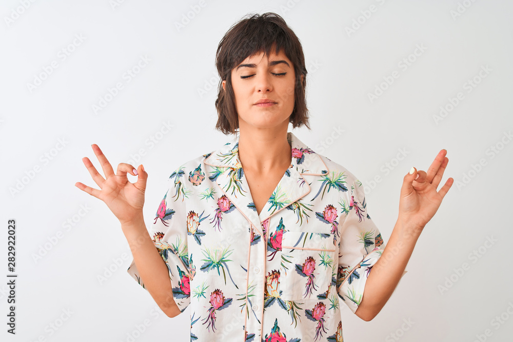 Beautiful woman on vacation wearing summer casual shirt over isolated white background relax and smiling with eyes closed doing meditation gesture with fingers. Yoga concept. Beautiful woman on vacation wearing summer casual shirt over isolated white background relax and smiling with eyes closed doing meditation gesture with fingers. Yoga concept.