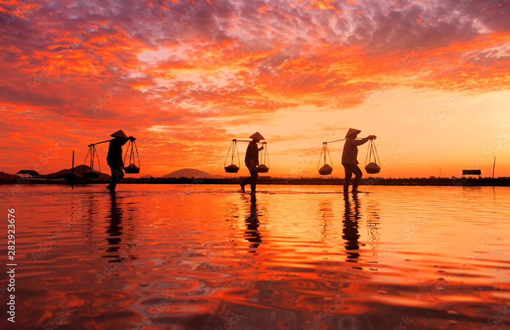 custom made wallpaper toronto digitalWoman carrying baskets of freshly harvested salt on their shoulders at sunrise in Hon Khoi salt field at sunrise, Nha Trang Province, Vietnam