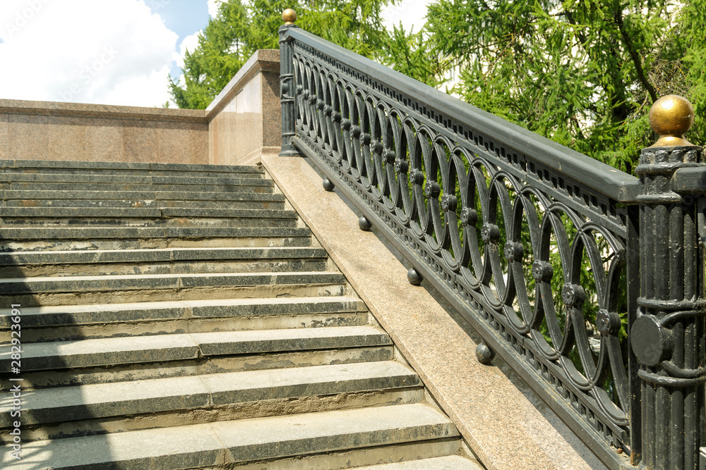 Fragment of a stone staircase with casting on the railing. Fragment of a stone staircase with casting on the railing.