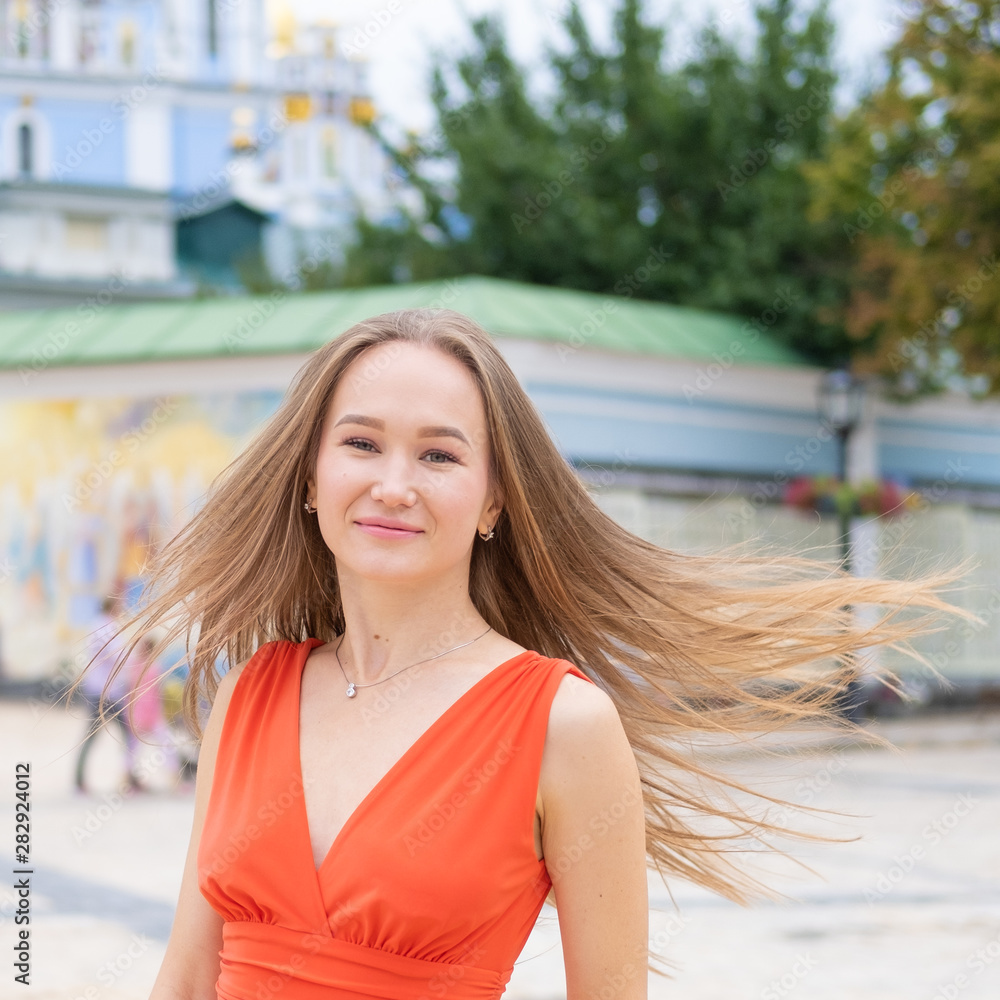 Attractive, Slim, Beautiful Girl Wearing White Shirt And Maxi Long Red Silk Fabric Skirt Fly And Wave In The Wind Walking. Fashion Concept