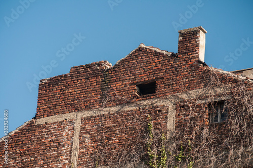 Backside old weathered vintage brick building wall facade