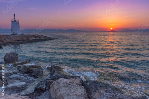 Old small lighthouse of the Aegina island, Saronic gulf, Greece, at sunset.