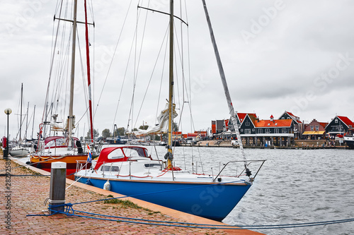 Volendam, Netherlands. Luxury yachts parked by pier in bay of North Sea.