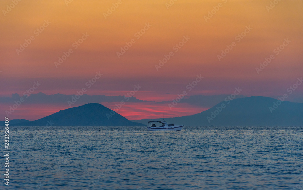 Fishing boat at sunset, in Greece. Fishing boat at sunset, in Greece.