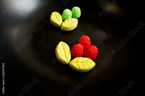 Fruit candy on black. Delicious fruit candy. Multicolored fruit candy.