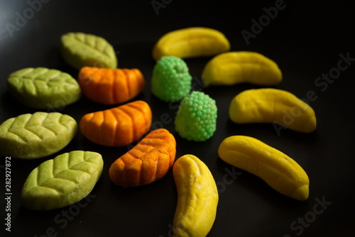 Fruit candy on black. Delicious fruit candy. Multicolored fruit candy.