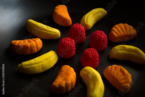 Fruit candy on black. Delicious fruit candy. Multicolored fruit candy.