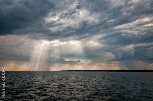 Dramatic sea landscape with rainy clouds © Piotr Wawrzyniuk