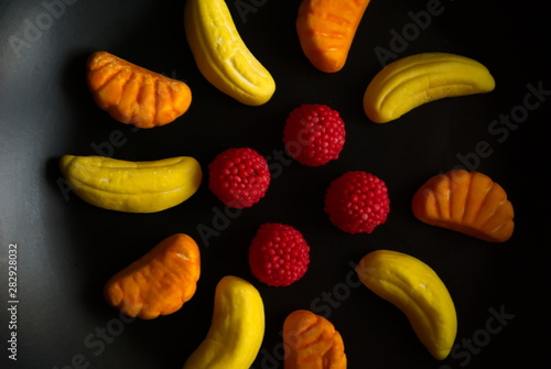 Fruit candy on black. Delicious fruit candy. Multicolored fruit candy.