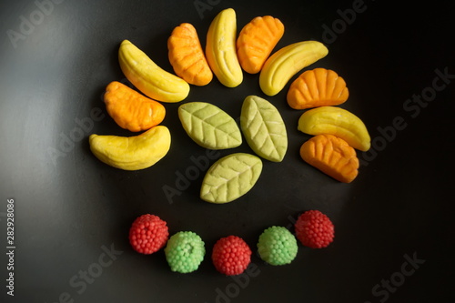 Fruit candy on black. Delicious fruit candy. Multicolored fruit candy.