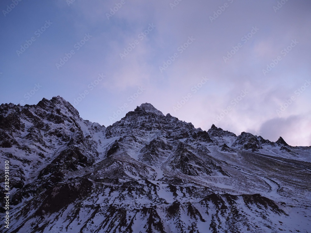 Fototapeta premium mountains in winter with snow and a pink sky in Iceland