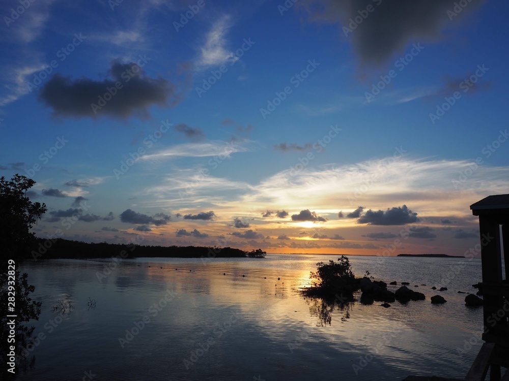 sunset over the sea with rocks in the shadow Miami florida USA 