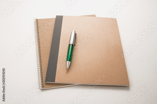  Notebooks and pen on white background