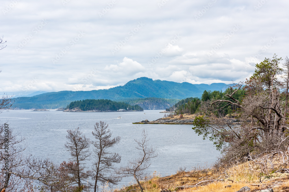 View over Inlet, ocean and island with boat and mountains in beautiful British Columbia. Canada.