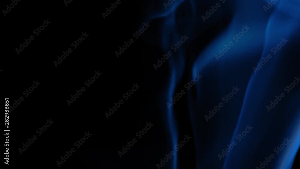 Trail of blue smoke rising up on black background Trail of blue smoke rising up on black background